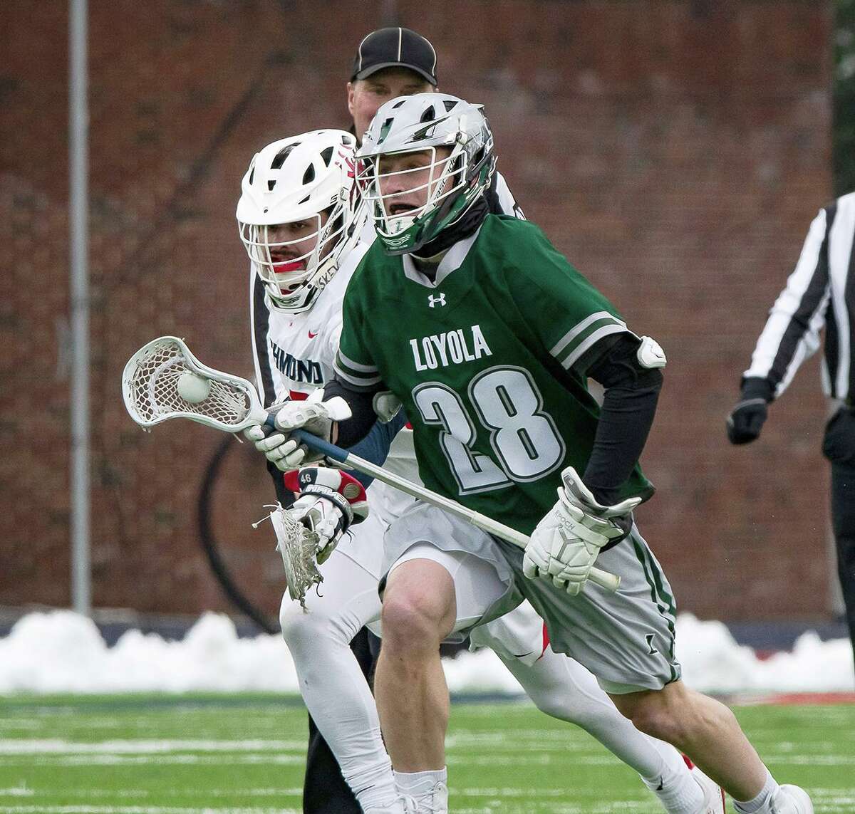 Bailey Savio of the Loyola Maryland men’s lacrosse team wins a faceoff against the University of Richmond on Feb. 14, 2021, at the Spiders’ Robbins Stadium.