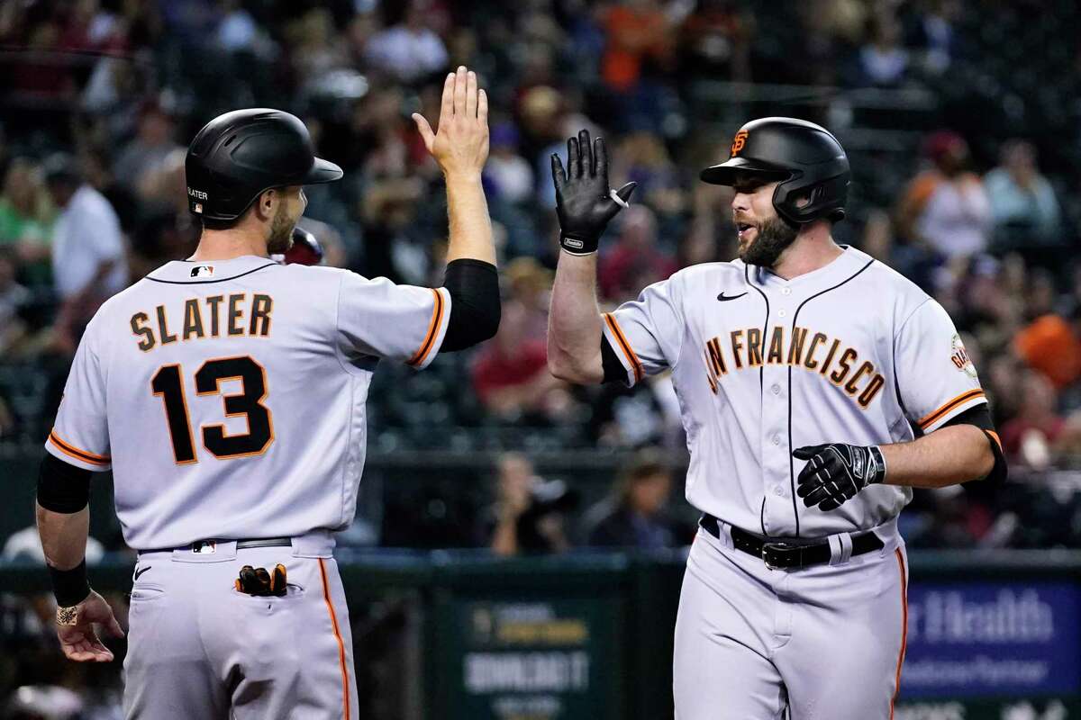 San Francisco Giants' Darin Ruf, right, celebrates his two-run home run against the Arizona Diamondbacks with Austin Slater (13) during the eighth inning of a baseball game Wednesday, July 6, 2022, in Phoenix. (AP Photo/Ross D. Franklin)