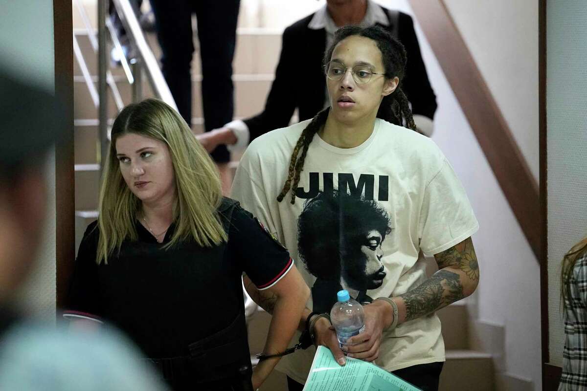 FILE - WNBA star and two-time Olympic gold medalist Brittney Griner is escorted to a courtroom for a hearing, in Khimki, just outside Moscow, Russia, July 1, 2022. Jailed American basketball star Brittney Griner returns to a Russian court Thursday July 7, 2022, as calls increase for Washington to do more to secure her release. Griner was detained in February at a Moscow airport after vape canisters with cannabis oil allegedly were found in her luggage.