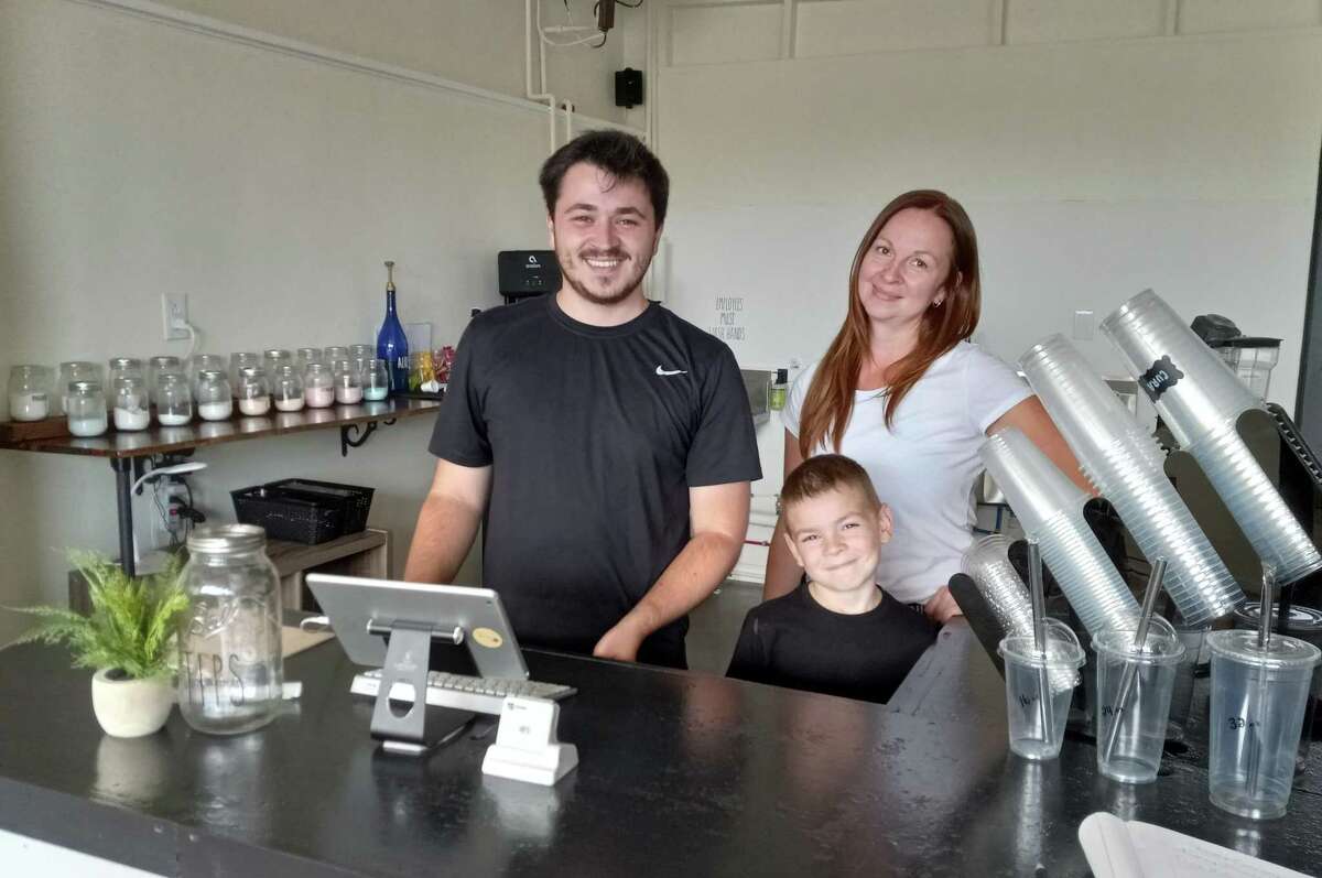 Rebecca Corcoran, right, owner of Cura Di Se Nutrition Club on Main Street, Winsted, runs the energy shake counter with her sons, Timmy and Turner.