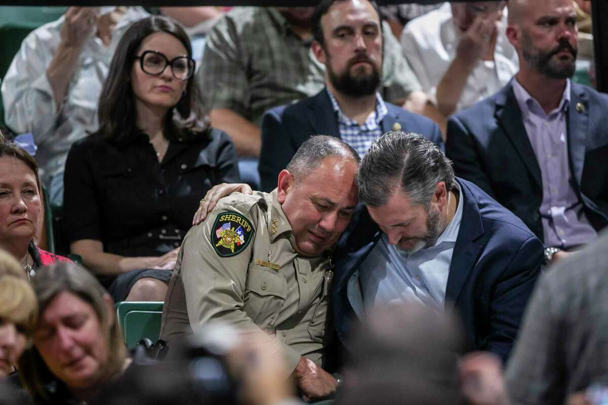 Uvalde County Sheriff Ruben Nolasco is comforted by Senator Ted Cruz during a vigil held in honor of the lives lost at Robb Elementary the day before at the Uvalde County Fairplex Arena in Uvalde, Texas, on May 25, 2022.