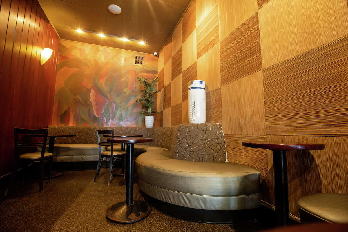 The back seating area features a vintage mural at Tony Niks in San Francisco, California July 7, 2022. Scala, a longtime patron and manager, is the new owner of Tony Niks, an old-fashioned bar in the heart of North Beach. He is committed to preserving his legacy.