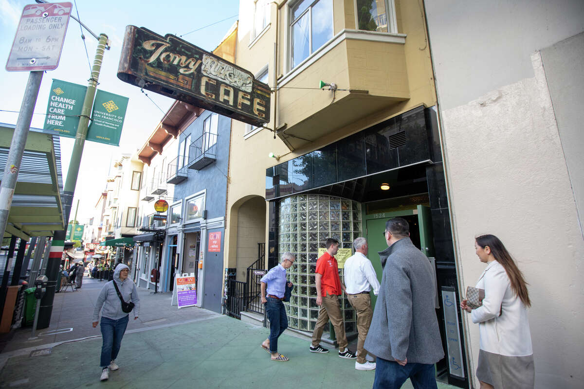 Patrons enter Tony Niks in San Francisco, California, July 7, 2022. Scala, a longtime patron and manager, is the new owner of Tony Niks, an old-fashioned bar in the heart of North Beach. He is committed to preserving his legacy.