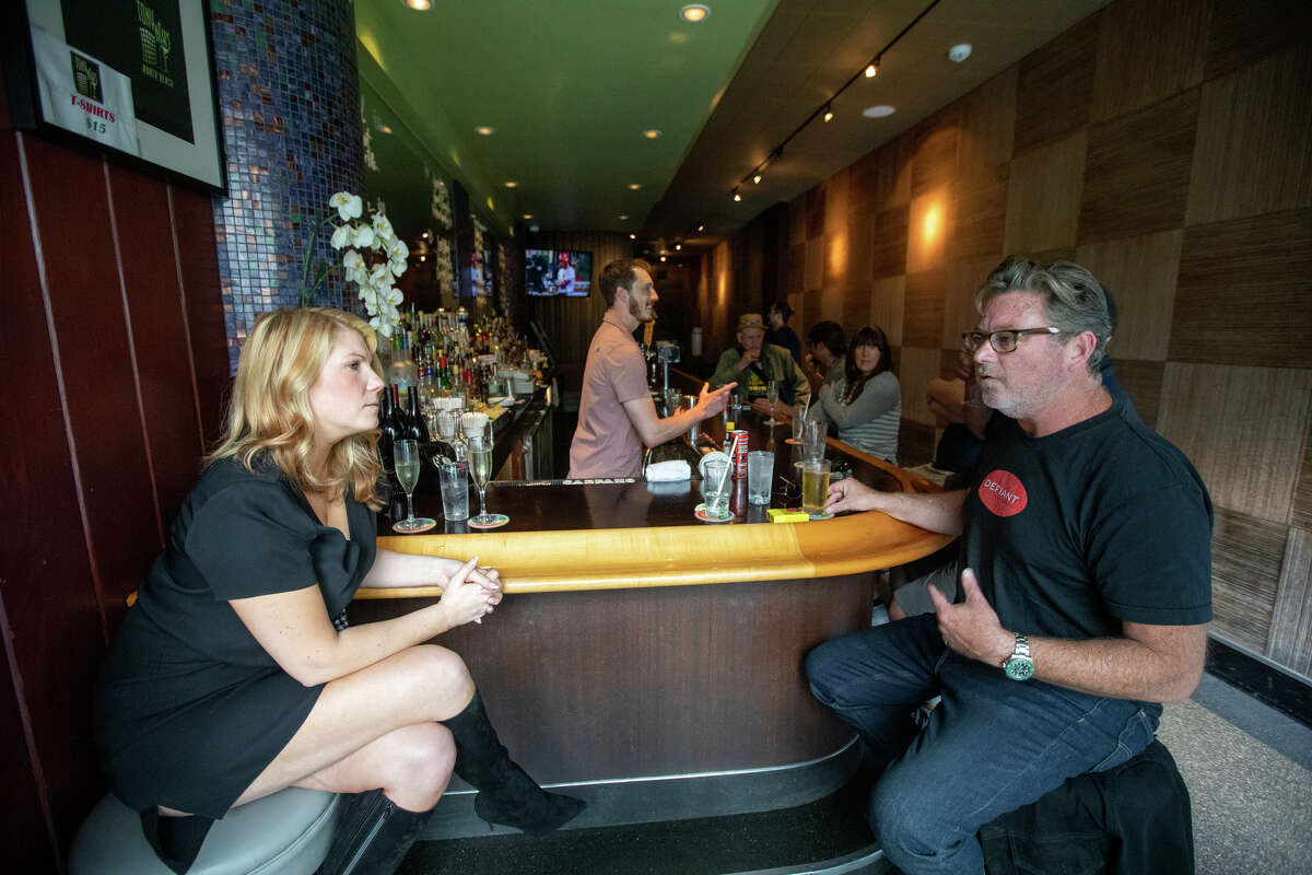 Regulars Danielle Westphal (left) and Mark Mounder share a conversation at Tony Niks in San Francisco, California on July 7, 2022. Sebastian Scala, a longtime patron and manager, is the new owner of Tony Niks, a former bar from in the heart of North Beach. He is committed to preserving his legacy.