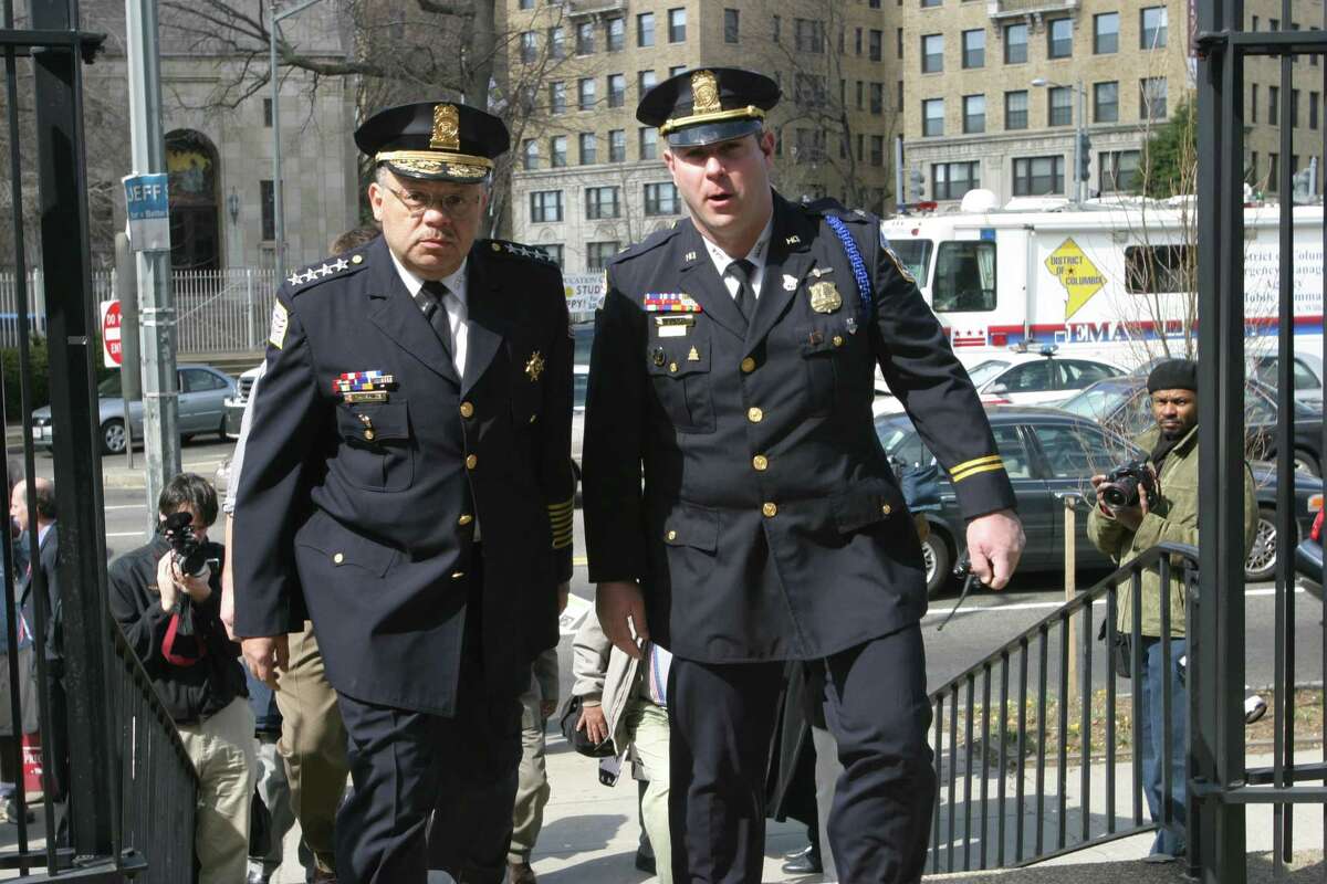 Brett Parson, right, walks into a funeral beside then-Washington, D.C., Police Chief Charles Ramsey, in 2005.