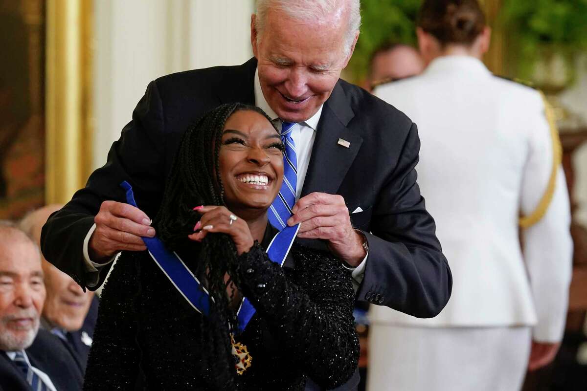 President Joe Biden awards the nation's highest civilian honor, the Presidential Medal of Freedom, to gymnast Simone Biles of Spring on Thursday at the White House in Washington.