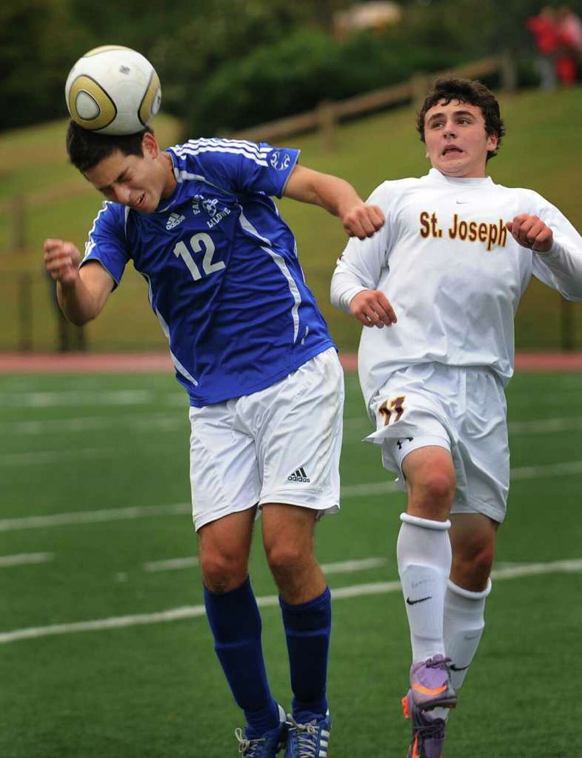 Fairfield Ludlowe's Ian Wolff heads the ball in front of St. Joseph's Zac Psaras during their teams' 0-0 tie at St. Joseph High School in Trumbull on Monday, October 4, 2010.