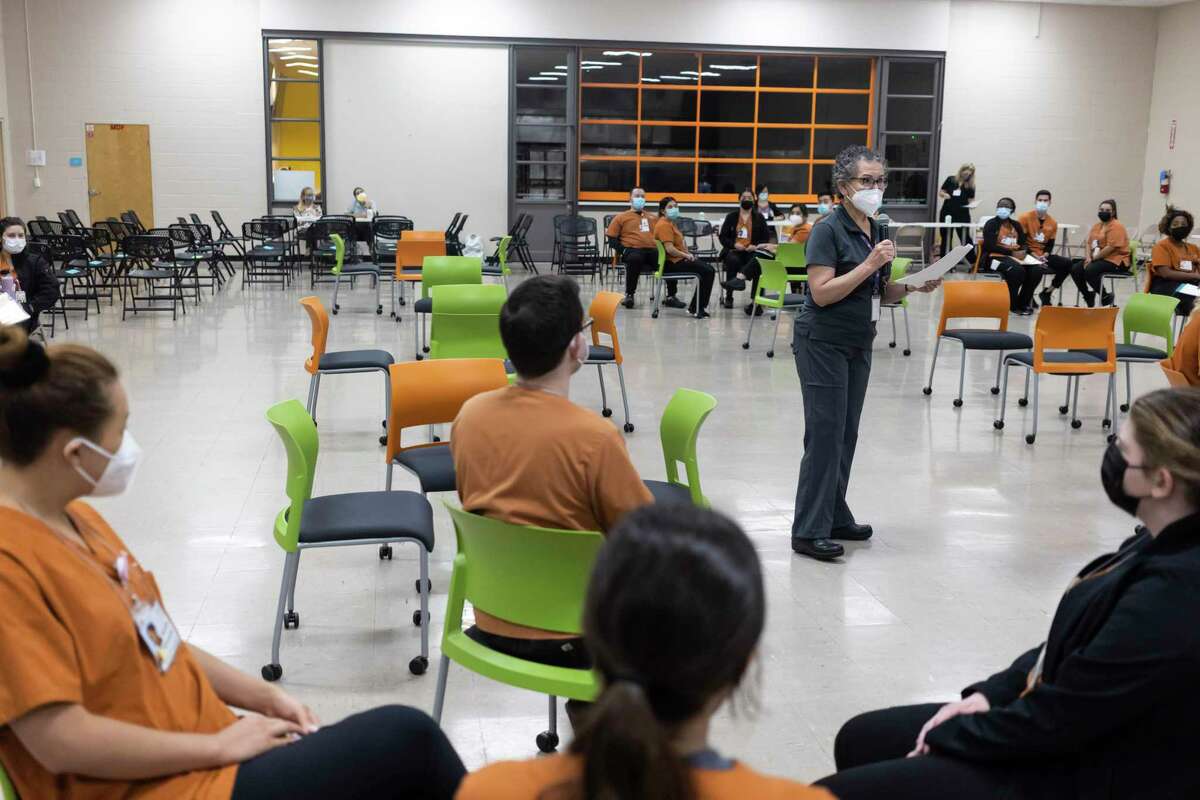 Adelita Cantu — a nurse, public health expert and associate professor at UT Health San Antonio — instructs students during a poverty simulation that she conducted at The Neighborhood Place in May. Cantu focuses on the health effects of pollution on San Antonio residents.
