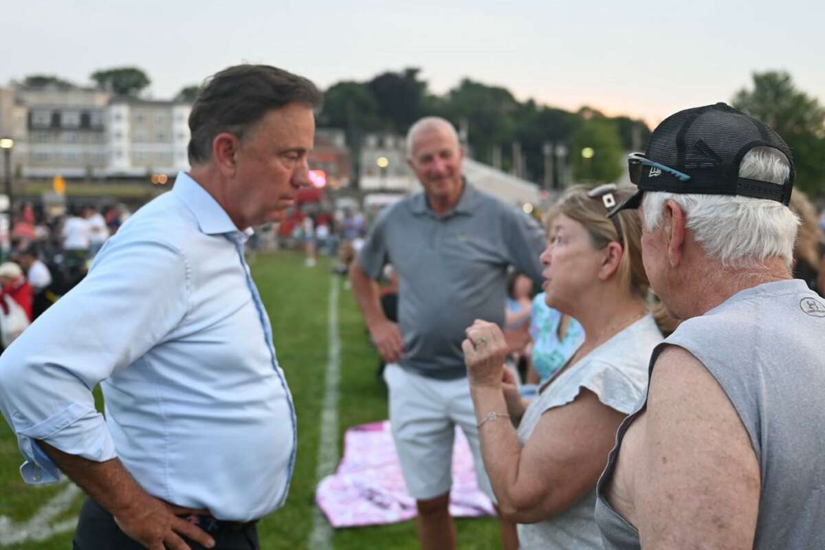 Gov. Ned Lamont, with Mayor Mark Lauretti looking on, talks with residents at the Shelton downtown concert and fireworks event on Monday, July 4.