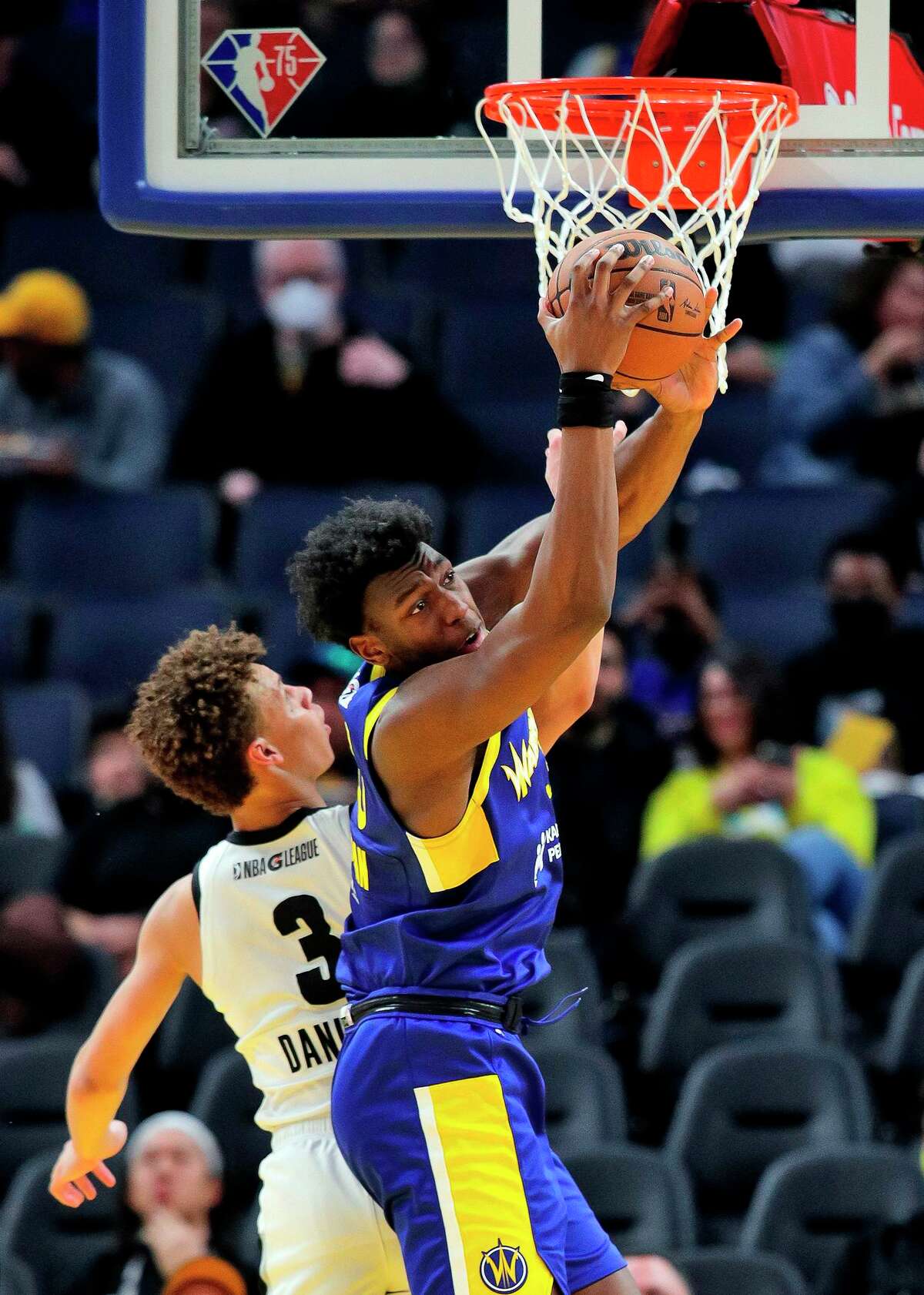 Center James Wiseman grabs a rebound agaist Dyson Daniels of G League Ignite during a game at Chase Center on March 13. Wiseman’s only action last season was two G League games.