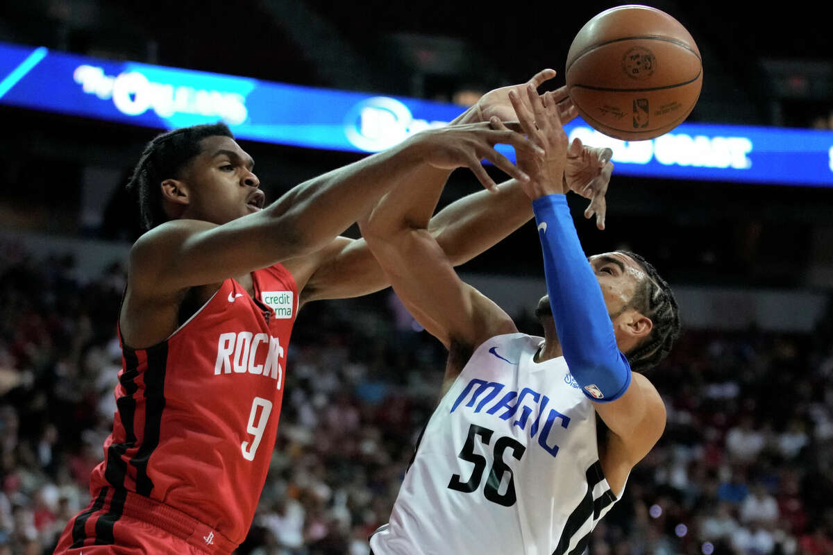 Houston Rockets' Josh Christopher, left, blocks a shot attempt by Orlando Magic's Justin James during the first half an NBA summer league basketball game Thursday, July 7, 2022, in Las Vegas.
