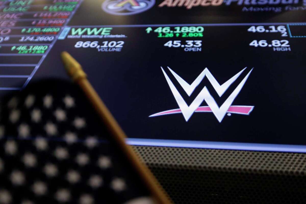 The logo for WWE appears above a trading post on the floor of the New York Stock Exchange, Tuesday, Feb. 18, 2020. Vince McMahon has voluntarily stepped back from his roles as CEO and chairman as the company’s board investigates his alleged misconduct.