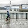 A king tide washes up along The Embarcadero in San Francisco, Calif. on Monday, Jan. 3, 2022. The tides have risen above areas along the boardwalk causing minor flooding.