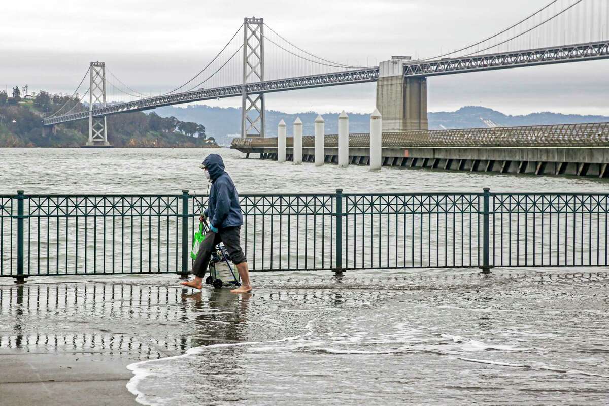 A king tide washes up along the Embarcadero in San Francisco on Jan. 3. The tides rose above areas along the boardwalk, causing minor flooding.
