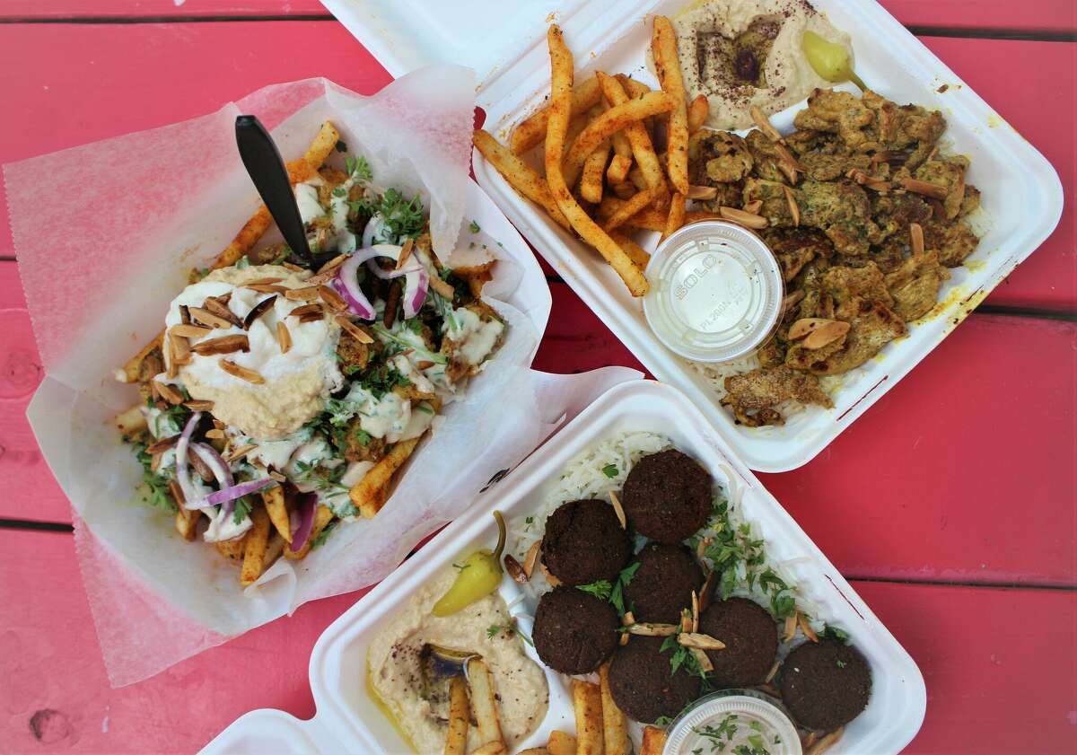 Shawarma fries, chicken combo plate, and falafel combo plate from The Pita Chick. 