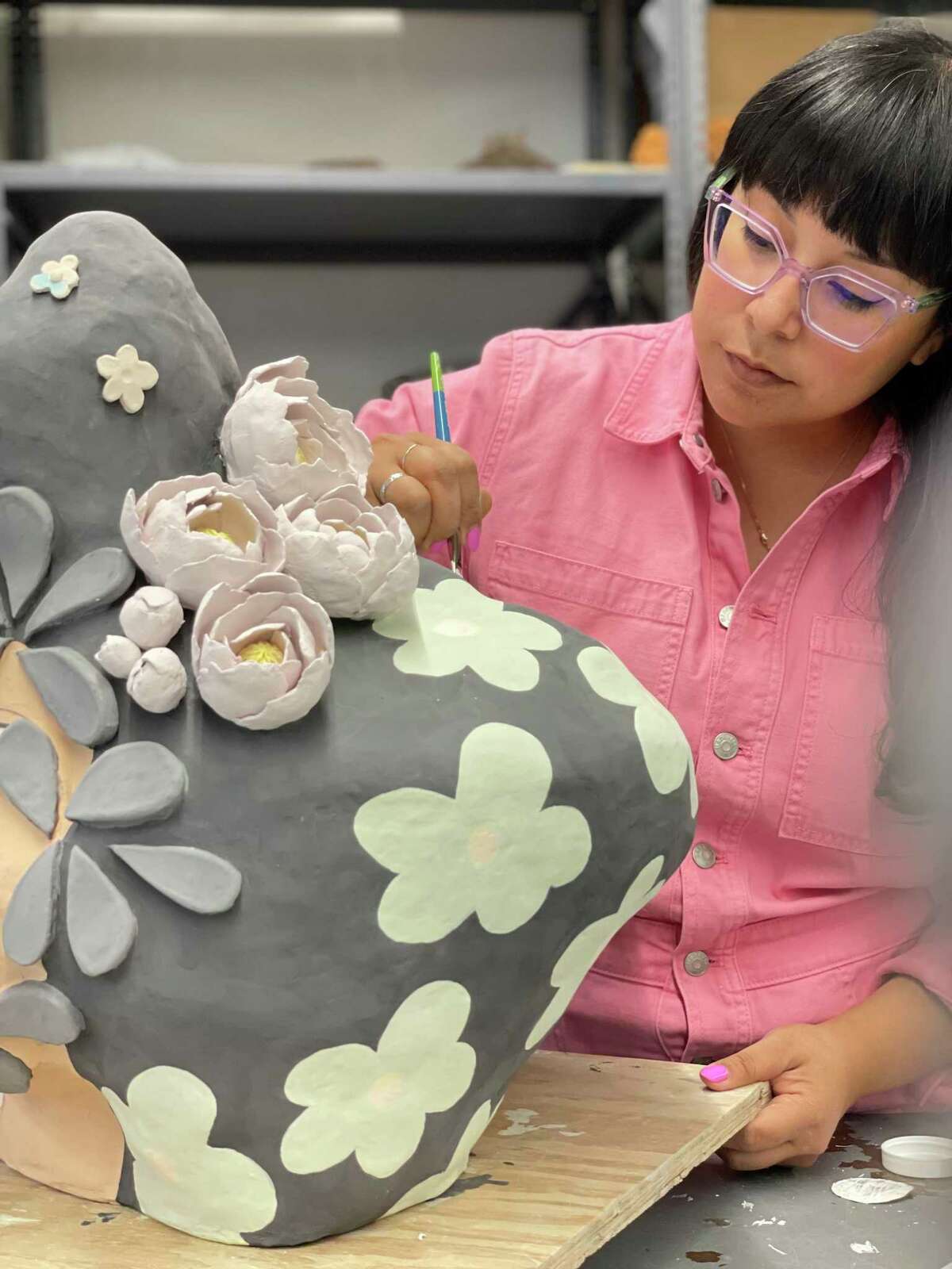 Jasmine Zalaya works on one of her ceramic pieces.  His works are exhibited at Art League Houston in his solo exhibition 