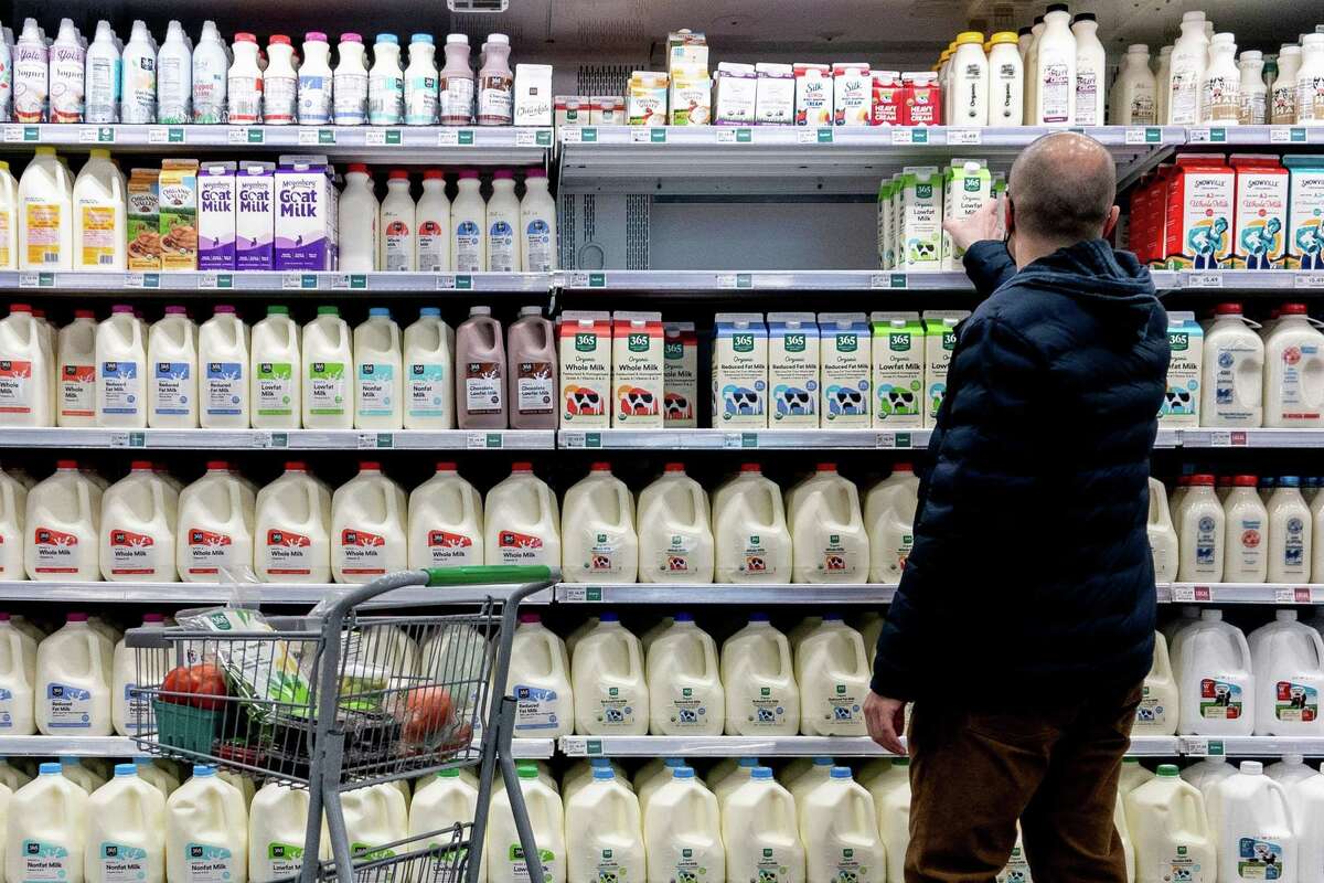A shopper walks through the dairy aisle of a grocery store in Washington, D.C., on Feb. 19, 2022. (Stefani Reynolds/AFP/Getty Images/TNS)