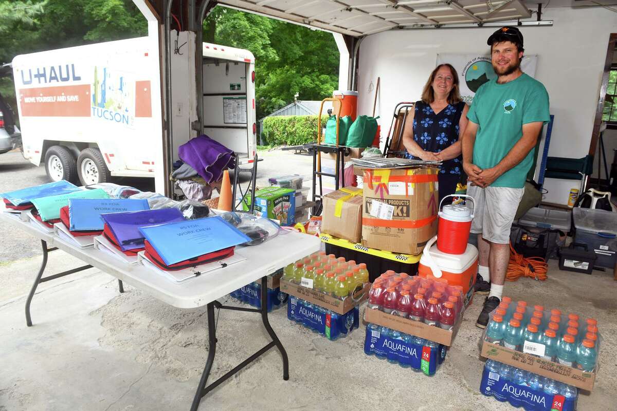 Lisa Peters and her son, Kyle, of Trumbull based Friends of Appalachia, pose in the garage of their Stratford, Conn. home as they prepare to load a trailer with donated goods that will be delivered to Kentucky, July 8, 2022.