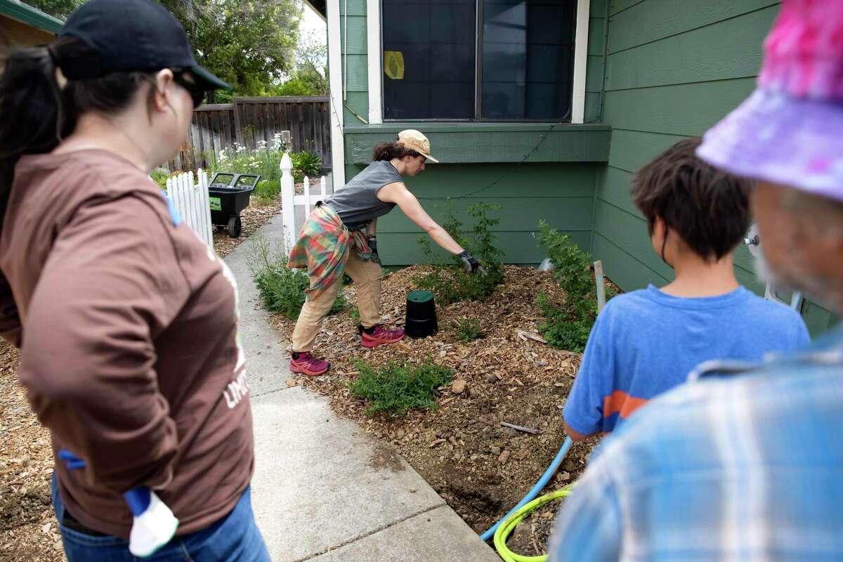 Nina Gordon-Kirsch, with Greywater Action, explains the process for digging mulch basins during a greywater installation demonstration at a Vallejo home.