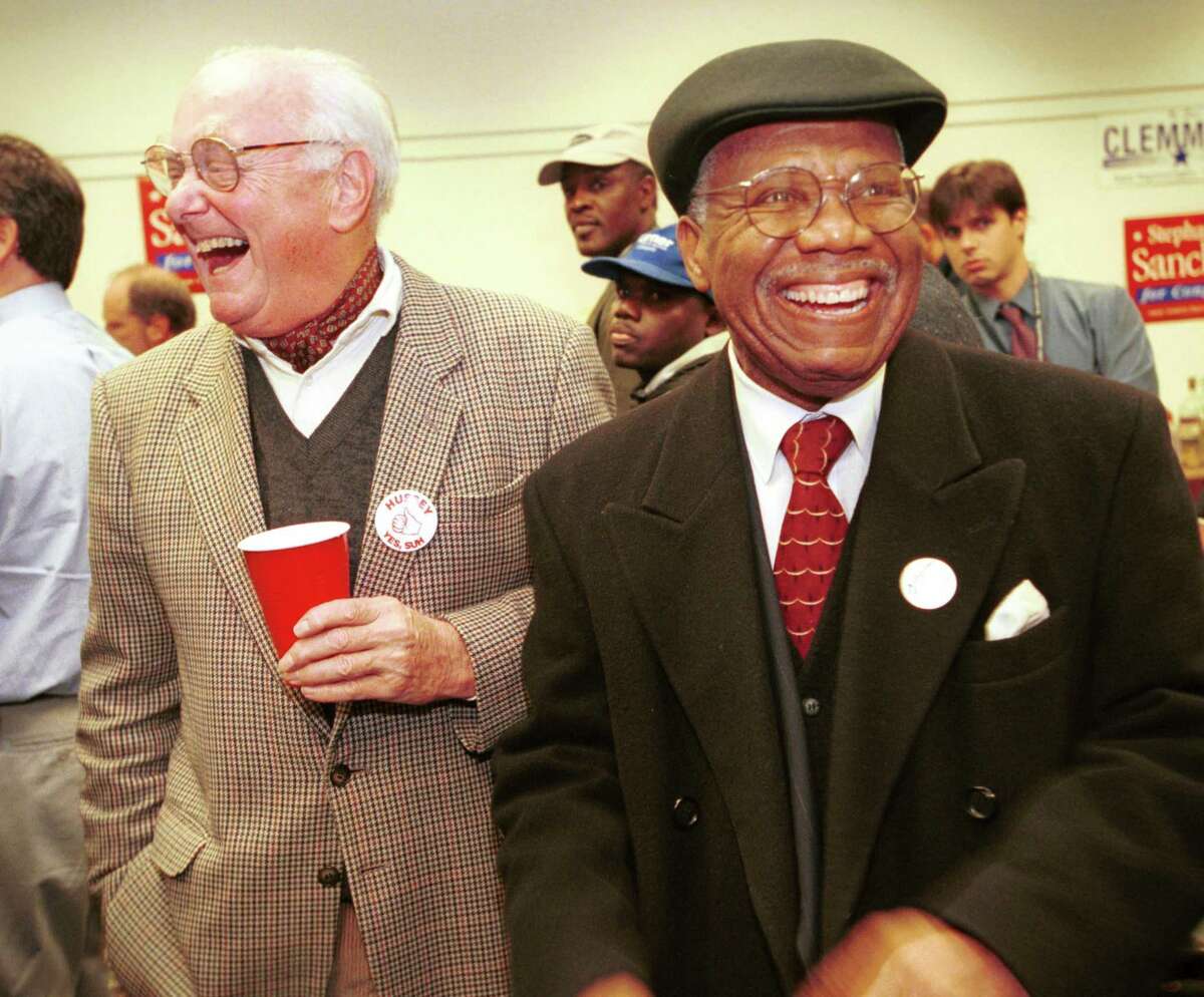 Candidates Peter Hussey, 141st House district, and the Reverend Joseph Clemmons, 140th House district, share a laugh at the Norwalk Democratic Headquarters on election day in 2001. Mark Conrad/Staff photo