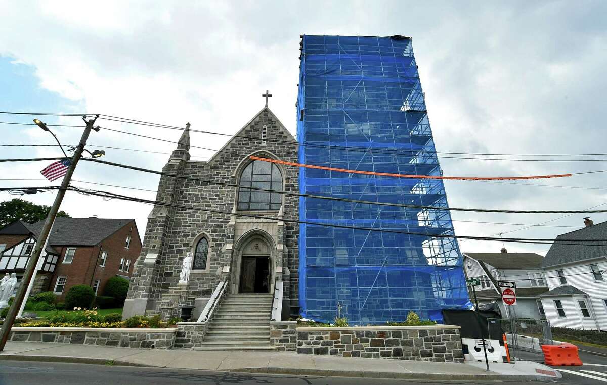 An exterior view of ongoing construction and restoration work at St. Roch's Church in Greenwich, Conn., on Friday July 8, 2022. Scaffolding is in place on part of the church’s historic stone facade.