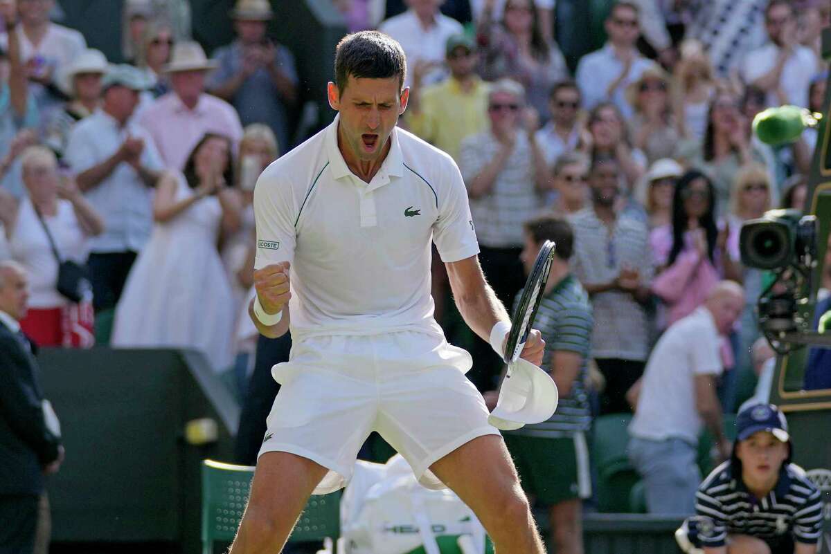 Novak Djokovic celebrates after beating Britain’s Cameron Norrie in a men’s singles semifinal on Day 12 at Wimbledon.