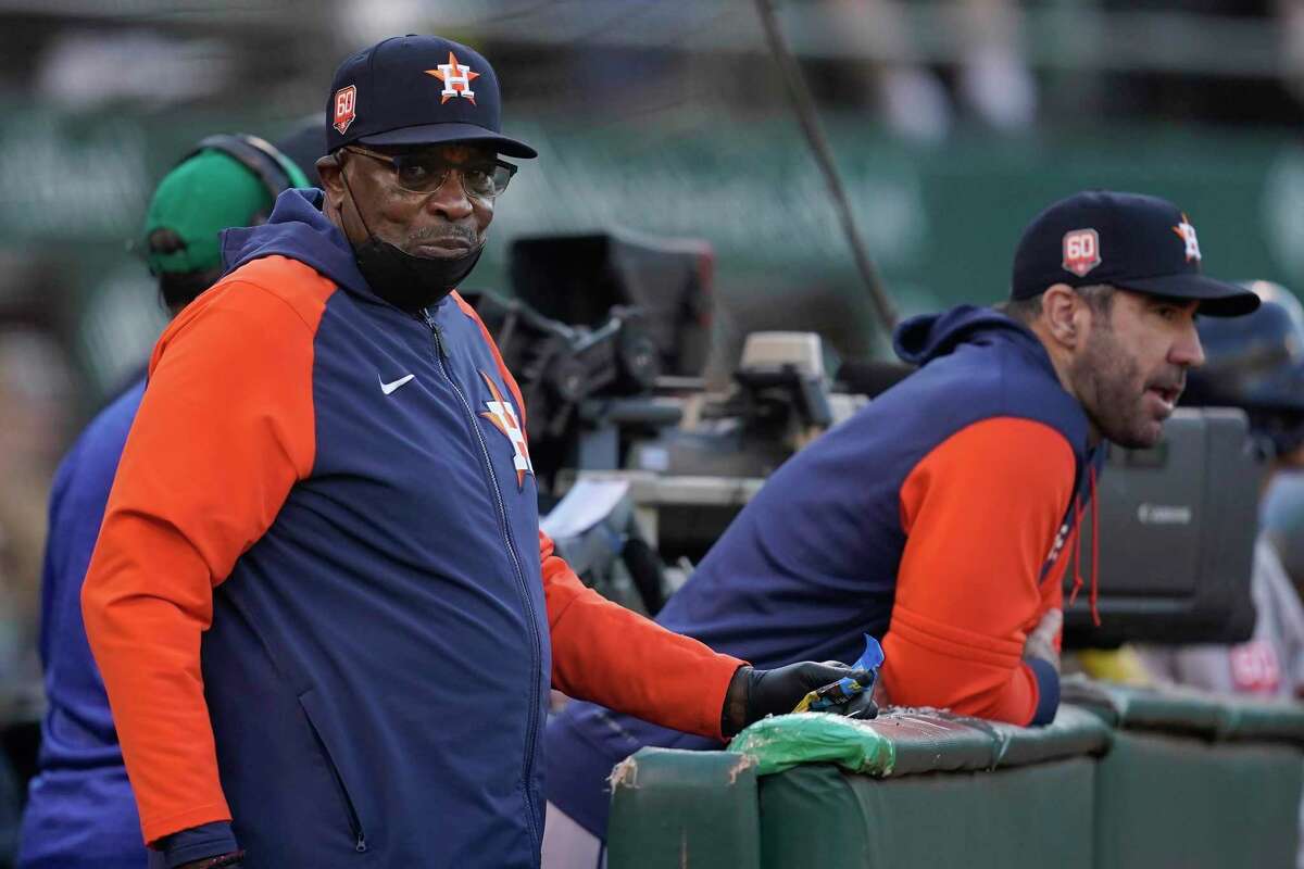 Houston Astros manager Dusty Baker Jr., left, and pitcher Justin Verlander watch during the fourth inning of a baseball game against the Oakland Athletics in Oakland, Calif., Friday, July 8, 2022. (AP Photo/Jeff Chiu)