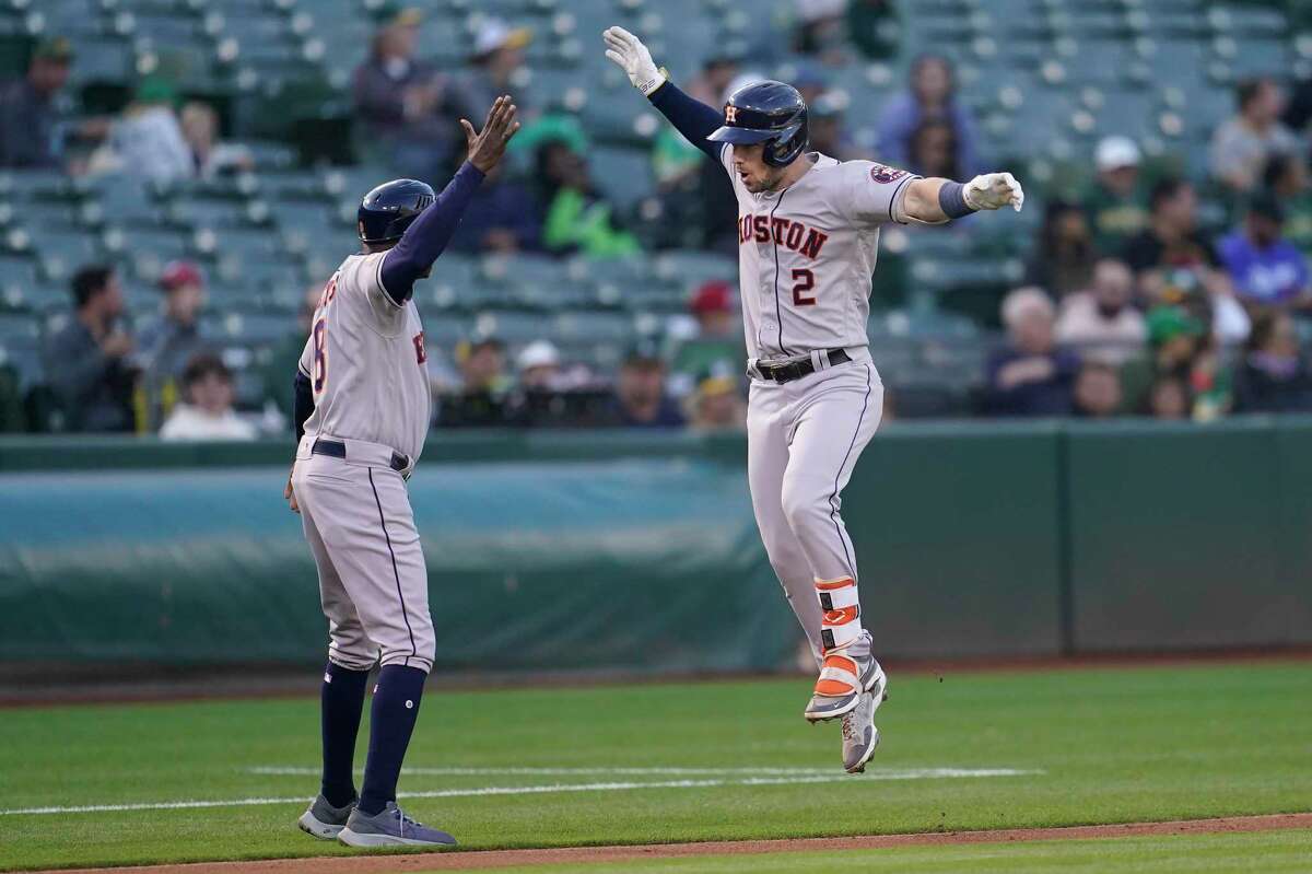 Houston Astros' Alex Bregman (2) is congratulated by third base coach Gary Pettis after hitting a two-run home run during the fourth inning of a baseball game against the Oakland Athletics in Oakland, Calif., Friday, July 8, 2022. (AP Photo/Jeff Chiu)