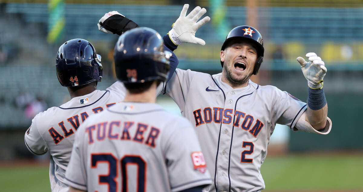 Alex Bregman #2 of the Houston Astros is congratulated by Yordan Alvarez #44 and Kyle Tucker #30 after he hit a home run in the fourth inning against the Oakland Athletics at RingCentral Coliseum on July 08, 2022 in Oakland, California. (Photo by Ezra Shaw/Getty Images)