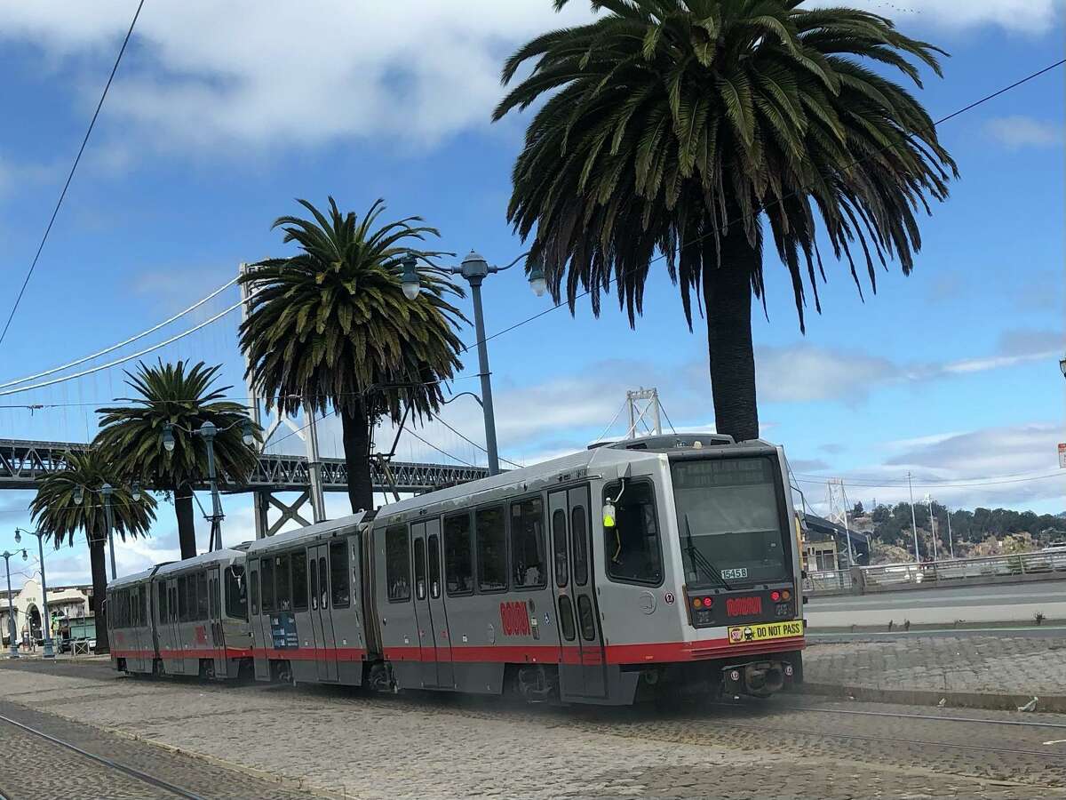The Muni K-T train rolls along on the Embarcadero in San Francisco.