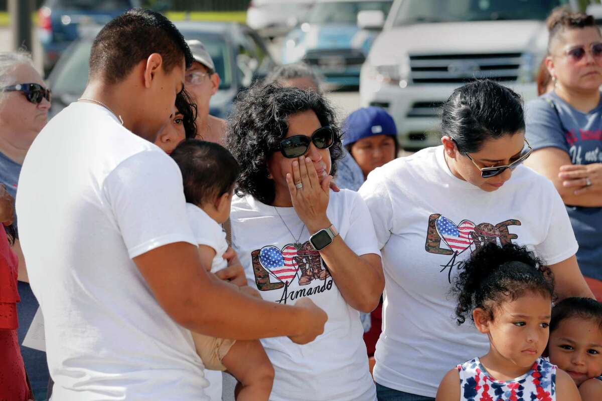 Ana Hernandez, middle, mother of Armando Hernandez, stands with other family members as she wipes away tears as “Amazing Grace” is sung during a plaque and bench dedication ceremony for U.S. Marine Corps Lance Cpl. Armando Hernandez.
