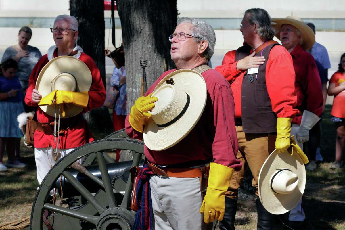 Members of the Lone Star Chapter #38 of The Sons of the Republic of Texas stand for the Texas Pledge during the Pioneer Adventure on Saturday in Conroe. Volunteers re-enacted period dress, weapons and life style of Texas during the mid 1800s for attendees at the Heritage Museum of Montgomery County.