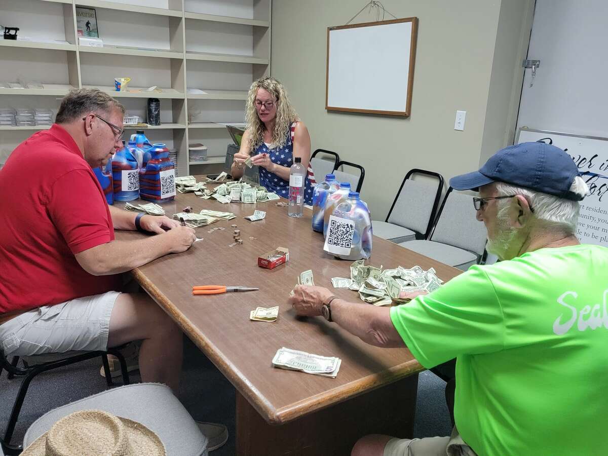 Donations collected for the Fourth of July fireworks show in Frankfort, collected during the Fourth of July parade, are counted by Bob McCall (right) James Martin (left) and Joanne Bartley (center) at the Frankfort-Elberta Chamber of Commerce.
