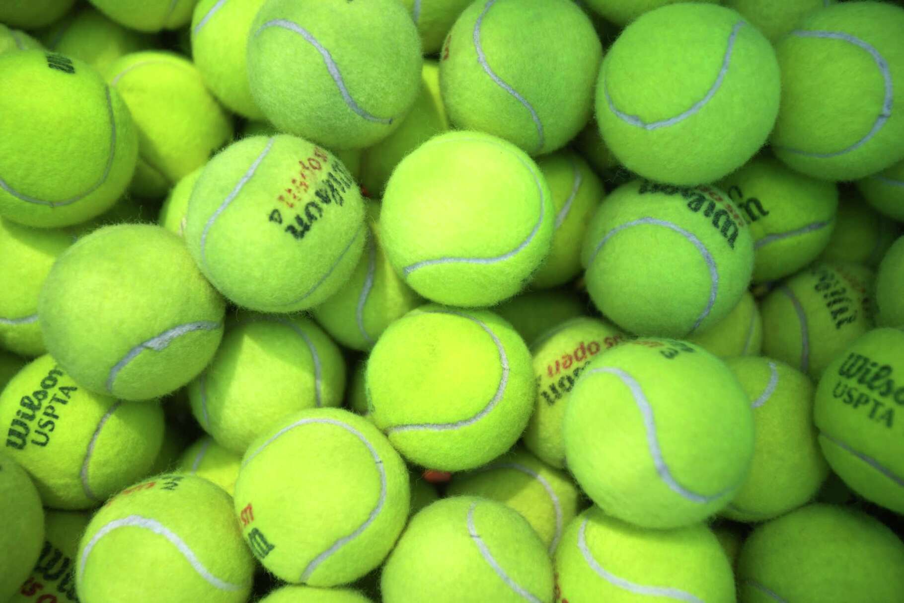 Tennis balls are gathered in a bucket during an International Wheelchair Tennis Camp for 20 kids and teens at the University of Houston Saturday, July 9, 2022 in Houston. Players are spending the week at UH, developing their skills on the court, bonding with fellow campers and exploring campus. The University’s Adaptive Athletics program is overseeing the event’s day-to-day activities and assisting campers, who hail from different areas of North America and South America. Only four of these camps take place worldwide. This is the first time an American university has played host.