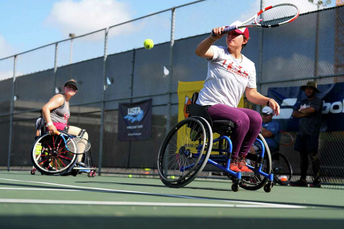 Sabina Czauz moves to make a shot as she plays doubles with Lily Lautenschlager, left, International Wheelchair Tennis Camp for 20 kids and teens at the University of Houston Saturday, July 9, 2022 in Houston. 