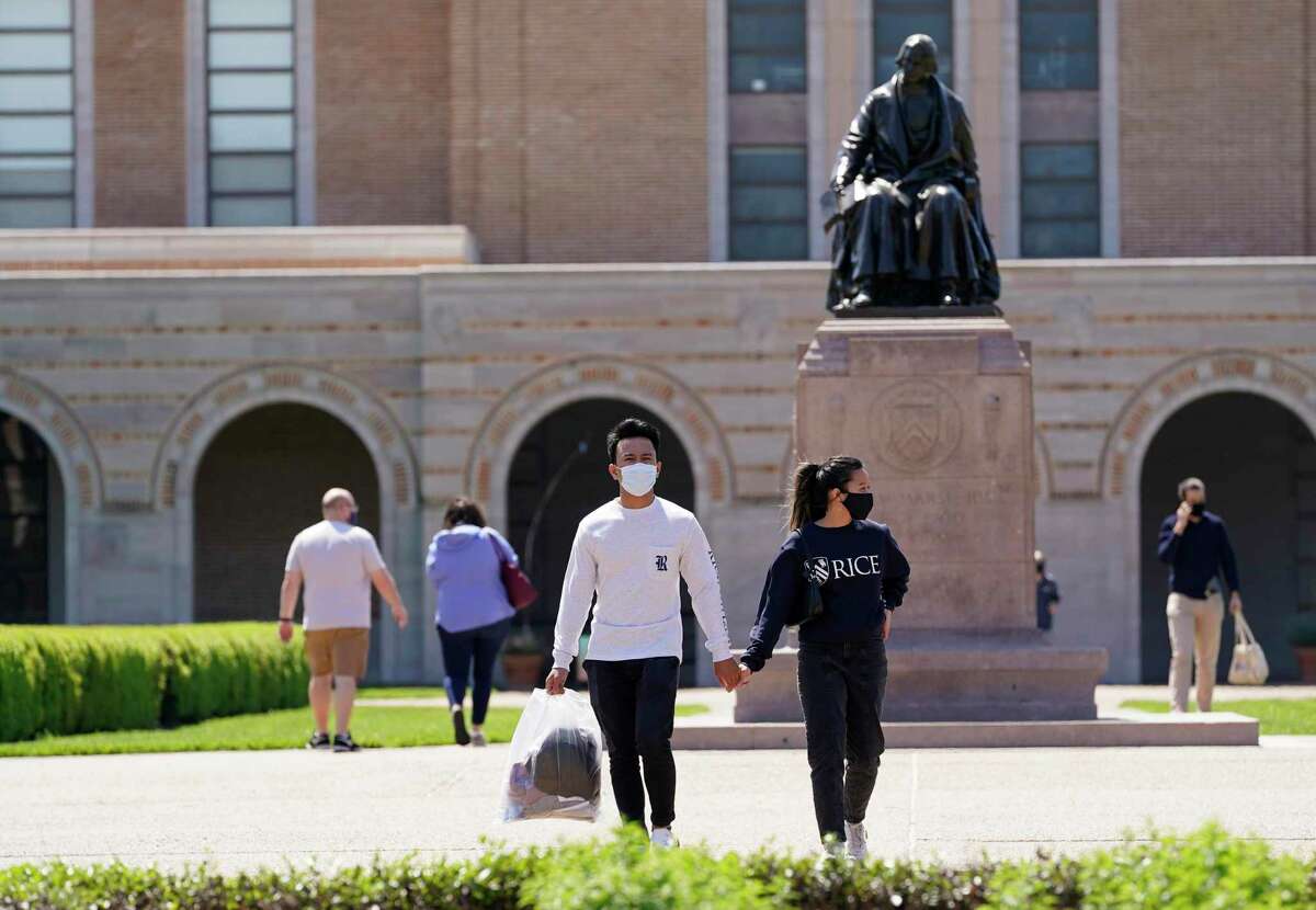 People walk on the campus of Rice University near the statue of the school’s namesake, William Marsh Rice, Thursday, April 1, 2021 in Houston. Rice University has announced an expansion of its student body and its campus. The physical expansion on the college’s 300 acres, will include a 12th residential college, a new engineering building, a building for the visual and dramatic arts, and a new student center that will largely replace the Rice Memorial Center.