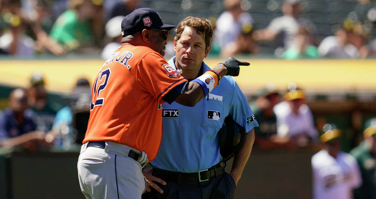 Houston Astros manager Dusty Baker Jr., left, argues with umpire Ben May, right, before being ejected during the eighth inning of a baseball game against the Oakland Athletics in Oakland, Calif., Saturday, July 9, 2022. (AP Photo/Godofredo A. Vasquez)
