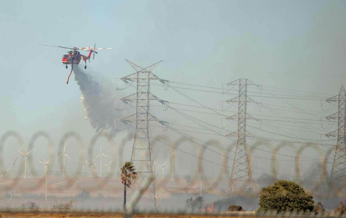 Firefighters battle the Marsh Fire in Pittsburg on Saturday, July 9, 2022.