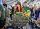 Helen Chinchilla, 27, of Modesto, with her dog Paris and spouse Dom Palomino, exit RingCentral Coliseum after the Oakland Athletics win the MLB game 6-0 against the Los Angeles Angels, Tuesday, July 20, 2021, in Oakland, Calif.