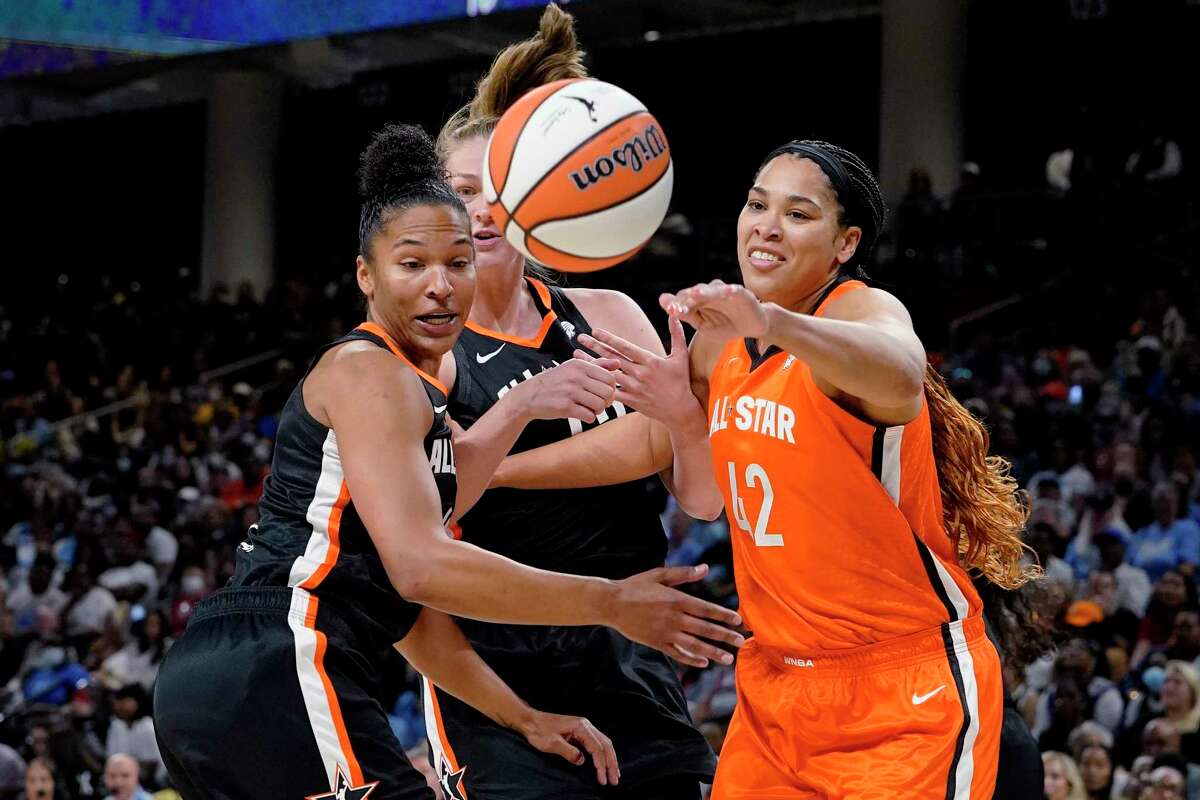 Team Wilson's Brionna Jones, right, battles for a loose ball against Team Stewart's Alyssa Thomas, left, and Emma Meesseman during the second half of a WNBA All-Star basketball game in Chicago, Sunday, July 10, 2022. (AP Photo/Nam Y. Huh)