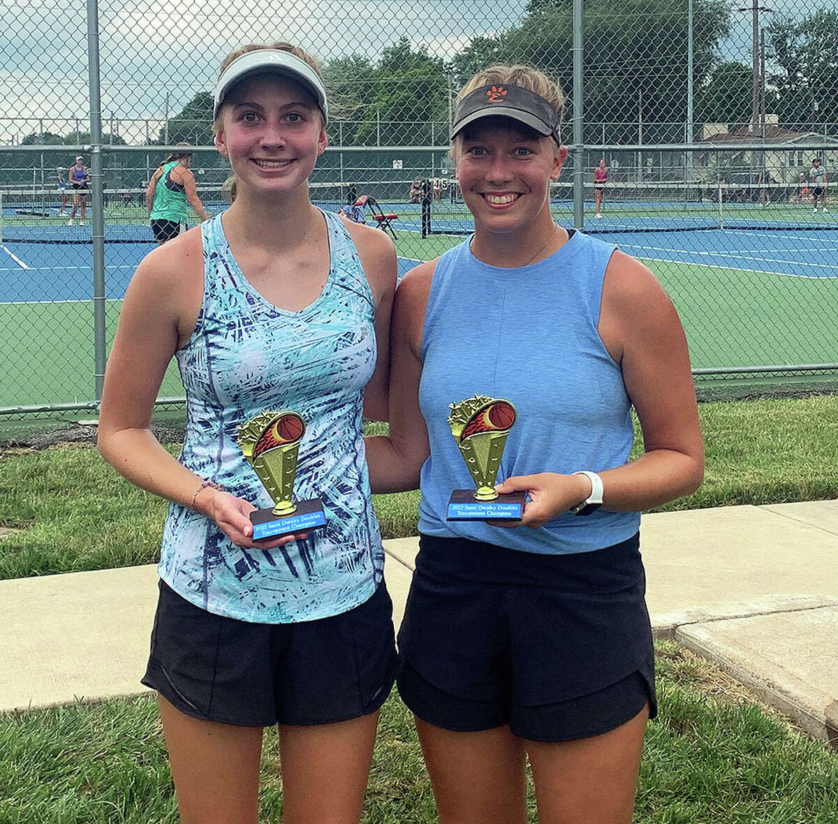 Women's open doubles champions Allysa Wise, left, and Hannah Colbert  pose after their 6-2, 6-1 win over Callahan Adams and Sarah Kreutztrager Saturday at the Sami Owsley Memorial Tennis Tournament at Roxana High School.