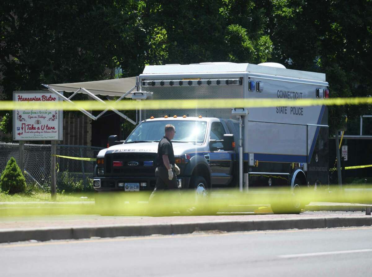 Investigators survey the scene of a shooting outside Calvin United Church of Christ in Fairfield, Conn. Sunday, July 10, 2022. Saturday night, a minor was shot and killed and another victim wounded from a single gunshot during a party at the church's banquet hall, according to police.