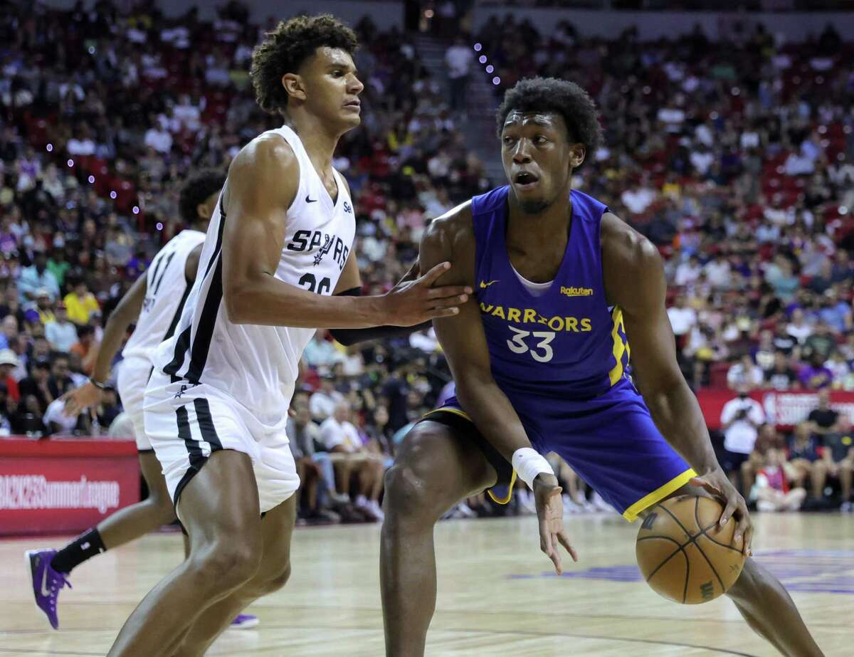 LAS VEGAS, NEVADA - JULY 10: James Wiseman #33 of the Golden State Warriors drives against Dominick Barlow #26 of the San Antonio Spurs during the 2022 NBA Summer League at the Thomas & Mack Center on July 10, 2022 in Las Vegas, Nevada. NOTE TO USER: User expressly acknowledges and agrees that, by downloading and or using this photograph, User is consenting to the terms and conditions of the Getty Images License Agreement. (Photo by Ethan Miller/Getty Images)