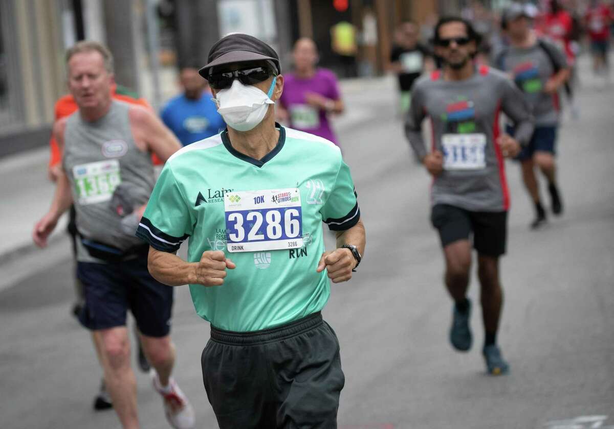 A masked runner participates in the Stars and Strides Run in San Jose.