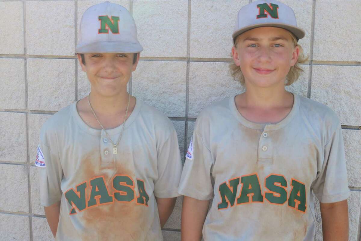 Their dirty uniforms help tell the story of how Jayden Klopfenstein (left) and Maddox Gushanas did their part to keep NASA Green 14s season alive this weekend. The two have a chance to play in Louisiana, but it will take a supreme effort this week to get there.