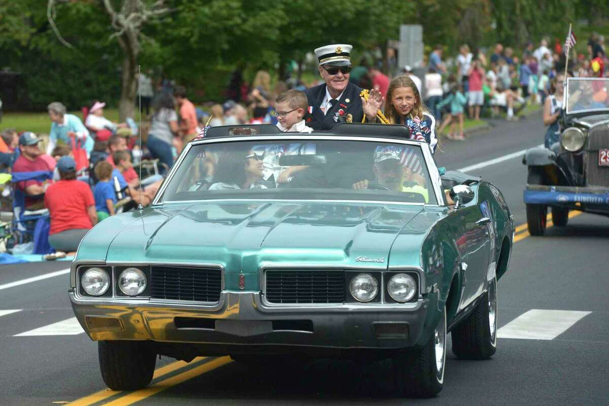 Grand Marshal William Halstead, fire chief of Sandy Hook Volunteer Fire and Rescue, rides in the 2019 Newtown Labor Day Parade with his grandchildren Emma Guilfoil and Ryan Halstead, Monday, Sept. 2, 2019, in Newtown, Conn. Halstead died Friday, July 8, 2022, shortly after returning home from a call.
