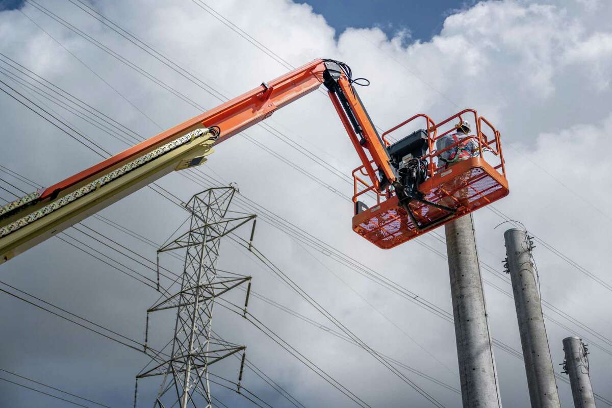 Technicians work to install transmission towers at the CenterPoint Energy power plant in Houston. Power demand in Texas is expected to set new all-time highs today as Texas experiences another day of record-breaking heat.