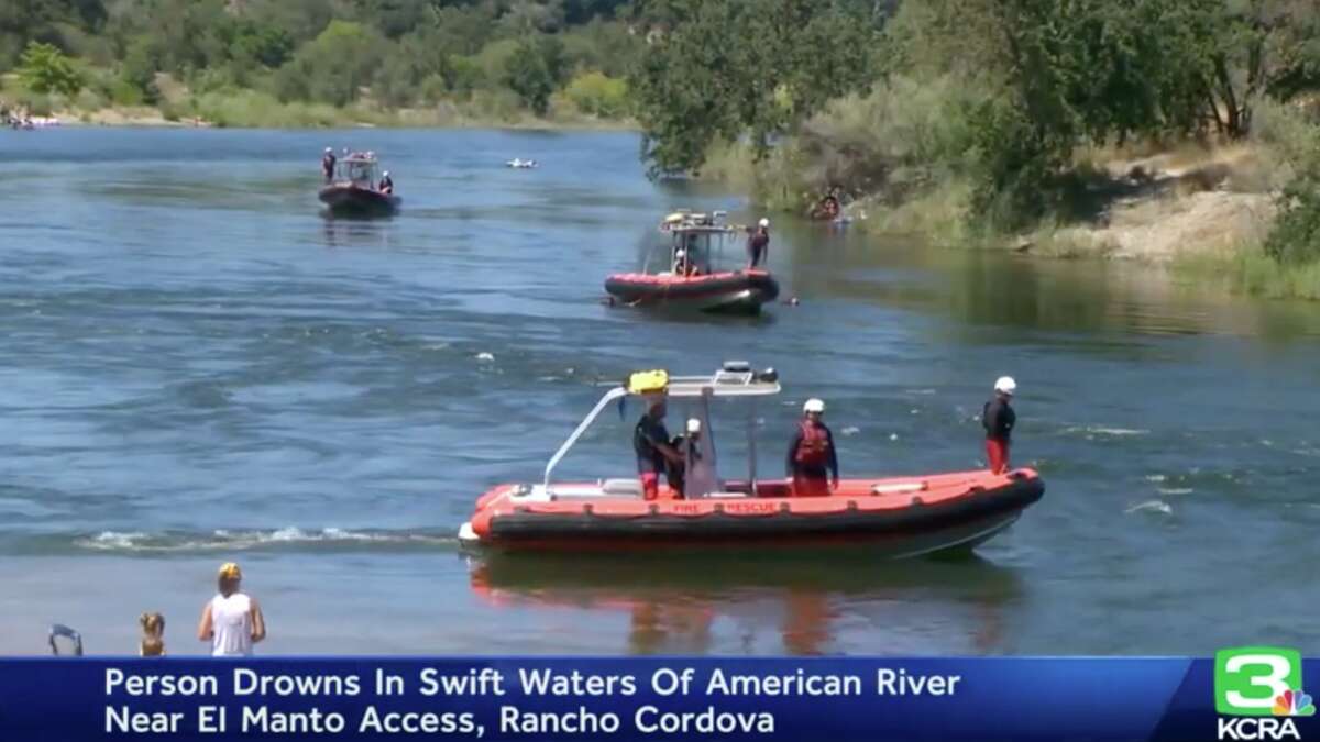 First responders look for a missing swimmer in the American River on July 9, 2022.