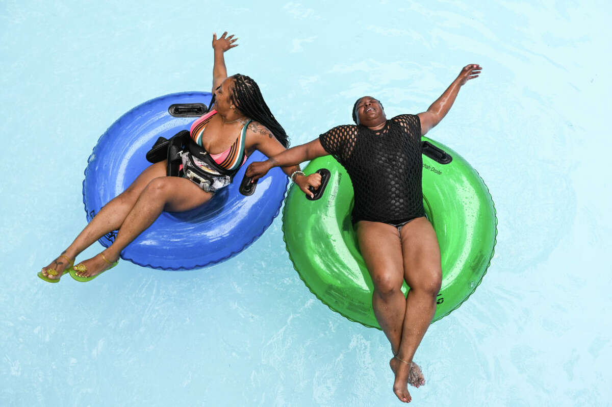 Two friends enjoy the lazy river at the water park Splish Splash in Calverton, New York, on June 12, 2021. 