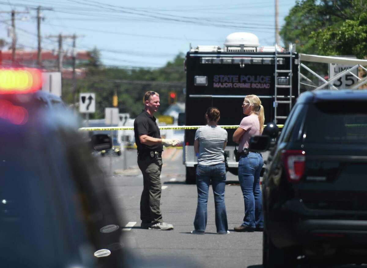 Investigators survey the scene of a shooting outside Calvin United Church of Christ in Fairfield on Sunday.